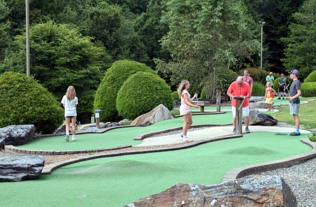 family playing mini golf