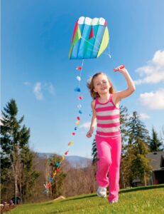 little girl playing with a kite